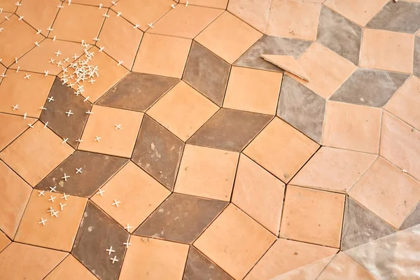 The combination of ceramic tiles in the form of rhombus. Kitchen renovation. Freshly glued High-quality Italian tiles