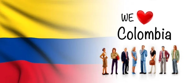 we love Colombia, A group of people pose next to the Colombian flag.