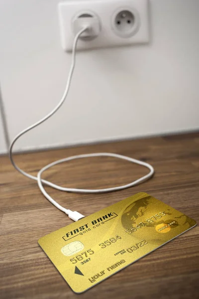 A gold bank card connected to a USB socket