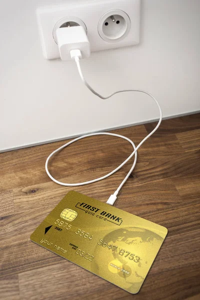 A gold bank card connected to a USB socket