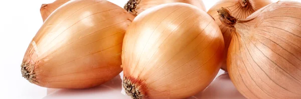 Food banner concept, organic vegetables and ingredients: close up of organic onions isolated on white background