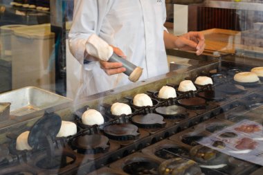 Dazaifu, Japonya - 19 Kasım 2018: Yerel şefler yapıyor Umegae mochi, ünlü yerel tatlı dolgu Dazaifu Tenmangu tapınak giriş, Japonya yakınındaki cadde boyunca kırmızı fasulye ile