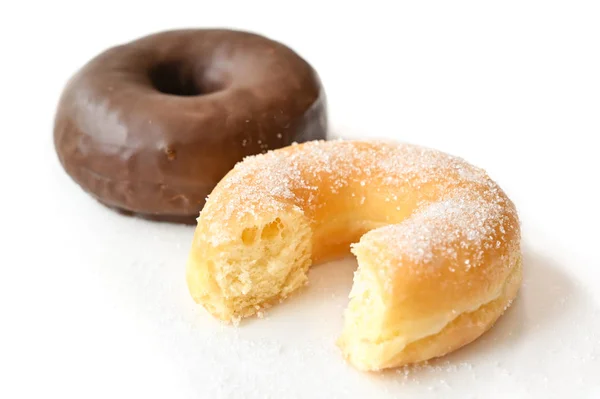 Glazed donut and chocolate donut on white background