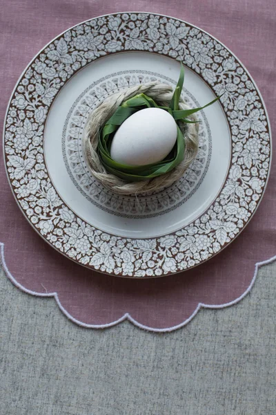 Chicken egg on the table, served with vintage dishes and tablecloths