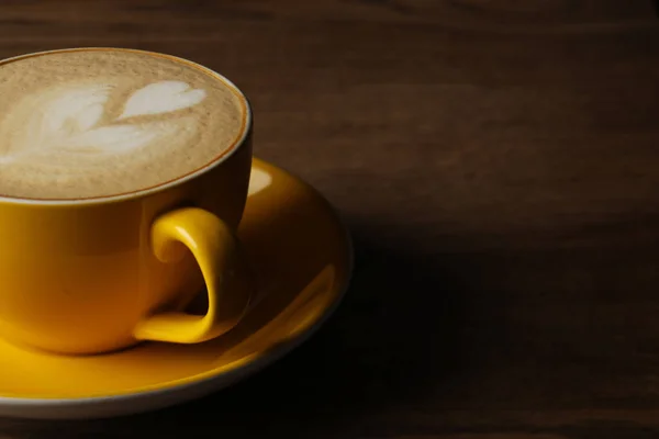 Cup of latte with heart on wooden table. Close up — Stock Photo, Image