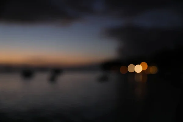 Out of focus twilight on the beach near the water