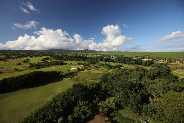 Top view on a lawn with trees against the sky with clouds