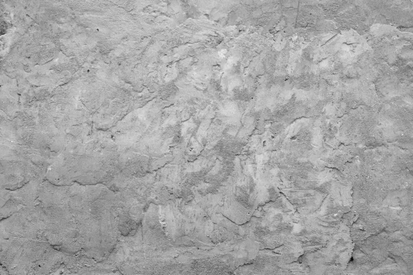 Closeup of a texture of gray finished concrete on a building wall.