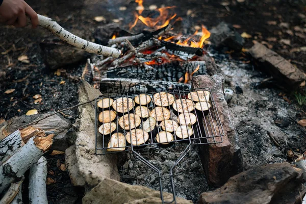 Grilled vegetables on a campfire on vacation. Small bonfire on outdoor recreation