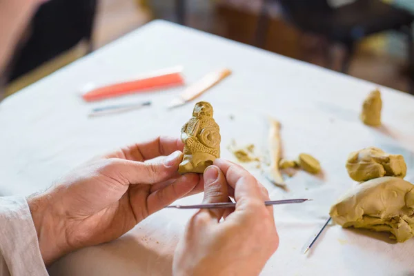 Potter making clay figure for board game — Stock Photo, Image