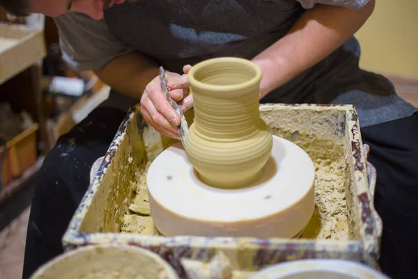 Professional potter shaping jug with special tool in pottery workshop — Stock Photo, Image