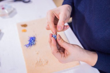 Designer making handmade eardrop clipart