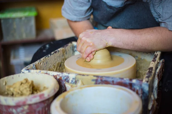 Professional male potter working with clay on potters wheel — Stock Photo, Image