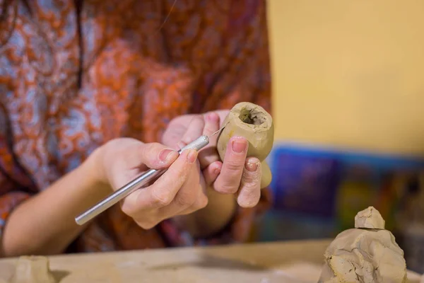 Woman potter making ceramic souvenir penny whistle in pottery workshop — Stock Photo, Image