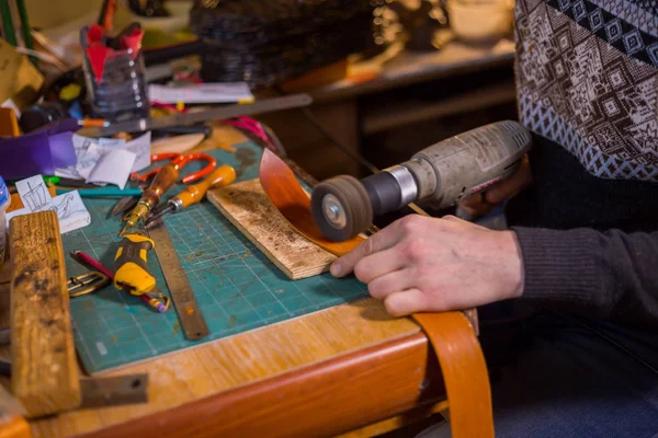 Skinner working with leather belt