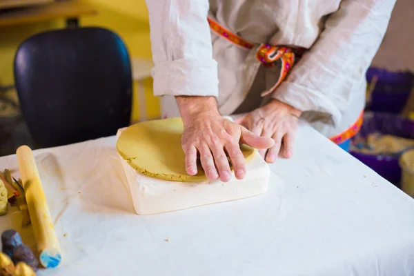 Potter making clay stamp picture