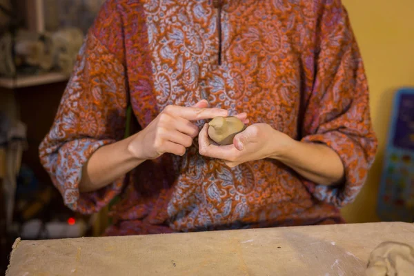 Woman potter making ceramic souvenir penny whistle in pottery workshop — Stock Photo, Image