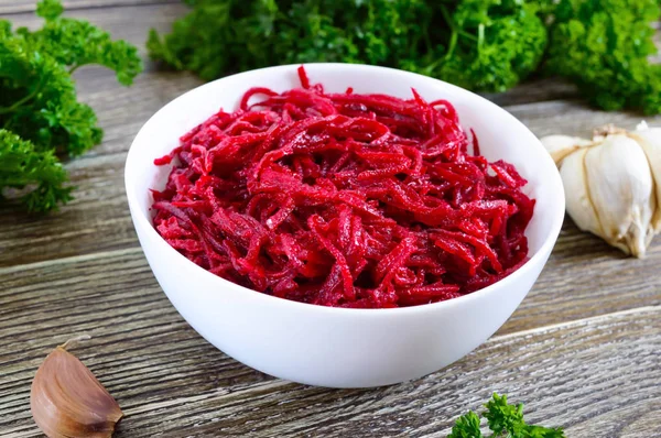 Vegetable salad from fresh  beets. Korean spicy salad in bowl on a wooden table. Top view. Vitamin menu. Vegan cuisine.