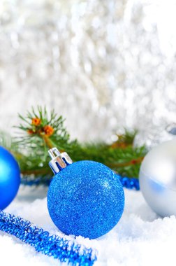 Kar, mavi ve gümüş Noel topları ile yeni yıl arka plan açık renkli yeşil dallarda çeki düzen vermek. Noel dekorasyon. Mutlu Noeller.