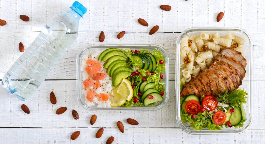 Different types of lunch boxes on a white wooden background. Top view, flat lay. Delicious healthy lunch. The concept of healthy eating. Banner
