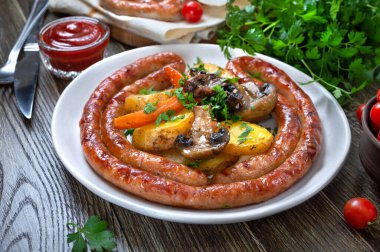 Ahşap zemin üzerinde fırında patates, mantar, vişneli domates ve ketçap ile ev yapımı lezzetli ızgara sosisler. Oktoberfest atıştırması. Yaz pikniği