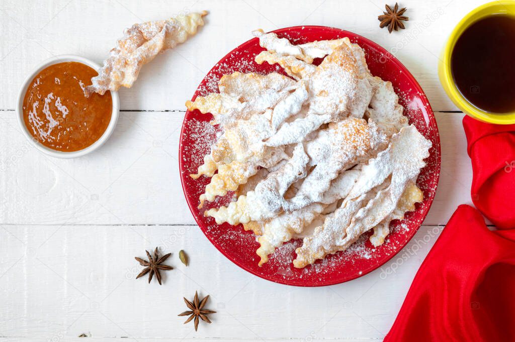 Brushwood - crispy deep fried cookies in powdered sugar with tea and jam. A traditional treat at European festivals.