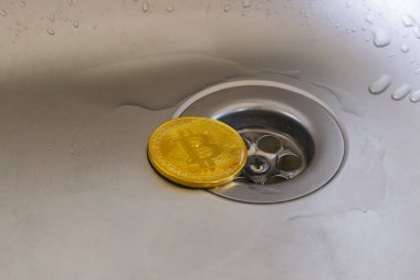 Altın bitcoin metal yüzeyi ile su damlaları.