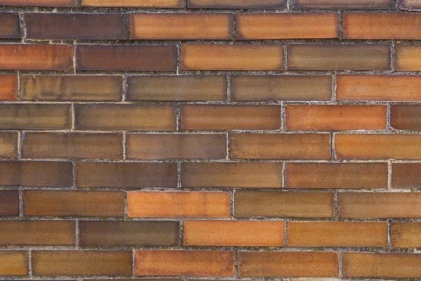 Brick background. The brick wall is built of rectangular blocks on cement mortar.