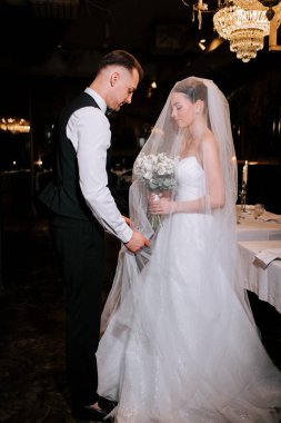 Couple exchanges heartfelt vows during a romantic wedding ceremony in an elegant venue