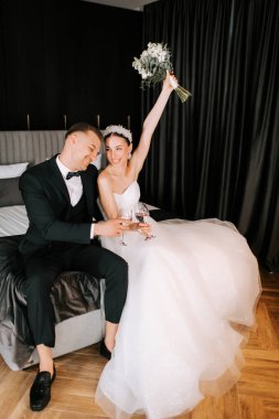 Couple celebrates their wedding with toasts and joy in elegant hotel setting