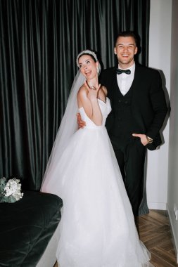 Couple celebrates their wedding day with joy in an elegant indoor setting