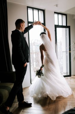 Elegant couple celebrates their wedding day in a beautifully lit indoor space
