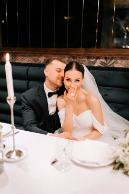 Couple celebrates their wedding with romance and joy at an elegant dinner table setting