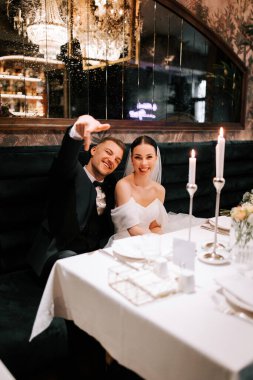 Couple celebrates their wedding at an elegant reception in a dimly lit venue