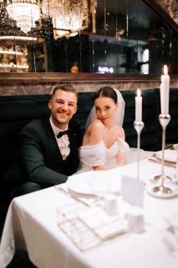 Couple enjoys an intimate dinner celebration at a romantic restaurant on their wedding night
