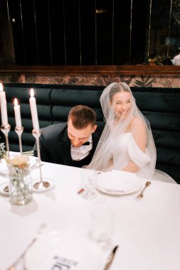 Wedding couple enjoying an intimate moment at a beautifully arranged reception table