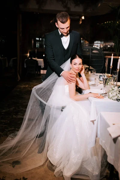 Elegant couple enjoying a romantic moment during their wedding reception at a beautiful venue