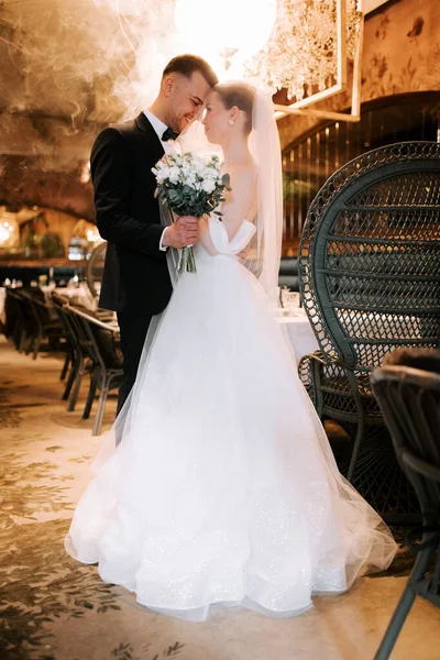 Couple celebrates their wedding in an elegant restaurant setting during a romantic evening