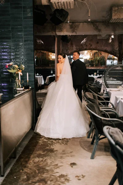 Couple enjoying a romantic moment after their wedding ceremony in an elegant restaurant