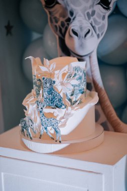 Beautifully designed cake featuring jungle animals for a festive celebration
