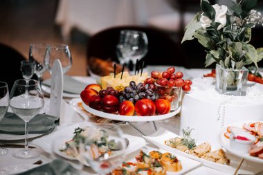 Colorful fruit and appetizers displayed elegantly on a table for a special event