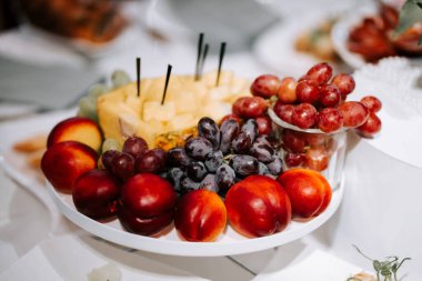 Colorful fruit platter with fresh grapes and nectarines at a summer gathering