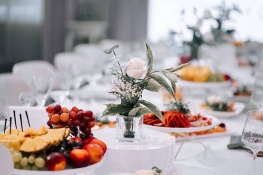 Elegant dining setup with fresh fruits and floral arrangements at a special event