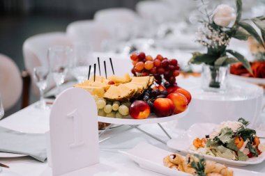 Elegant fruit display at a festive event with decorative table settings