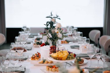 Elegant table setting with food and drinks for a special occasion in a tasteful venue