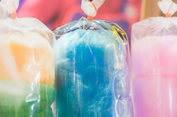 Various colors of cotton candy in plastic bag.