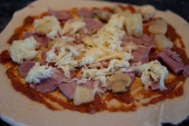 Jambon, ketçap ve mantar gibi çeşitli malzemelerle hazırlanmış pizza sosu..