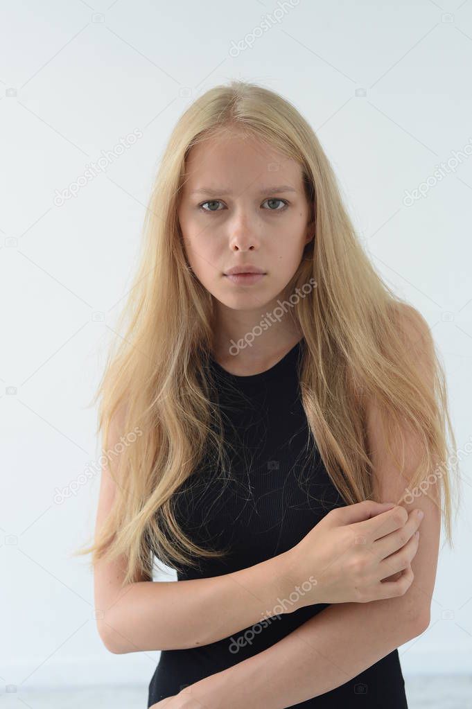 beautiful girl in black swimsuit with white hair smiling and showing emotions in the Studio