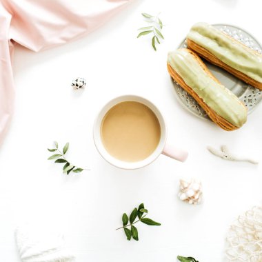 Kahve kupa, fıstıklı kek, Pembe battaniye, dize çanta, beyaz zemin üzerine deniz kabuklarını. Pastel kompozisyon tarz düz yatıyordu, en iyi görünümü.