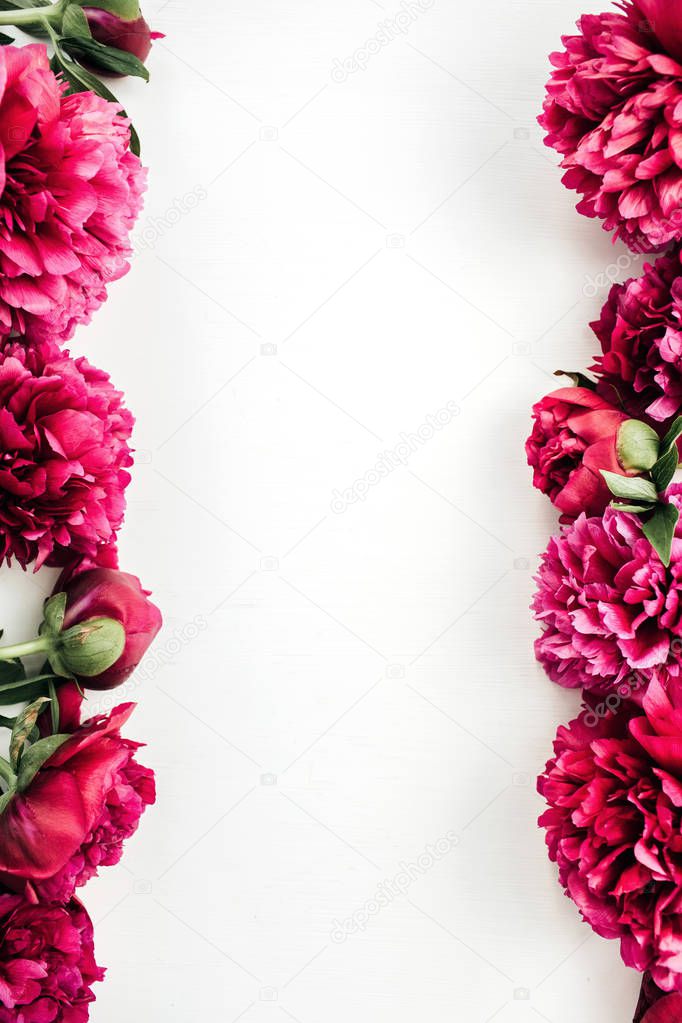 Frame of pink peony flowers on white background. Flat lay, top view mock up border.